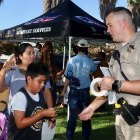 CHP Officer Nathen Howard talks to parents at Heritage Park.